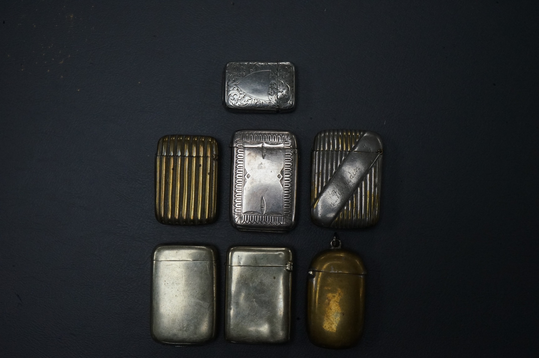 Seven base metal vesta cases, largest 6cm high